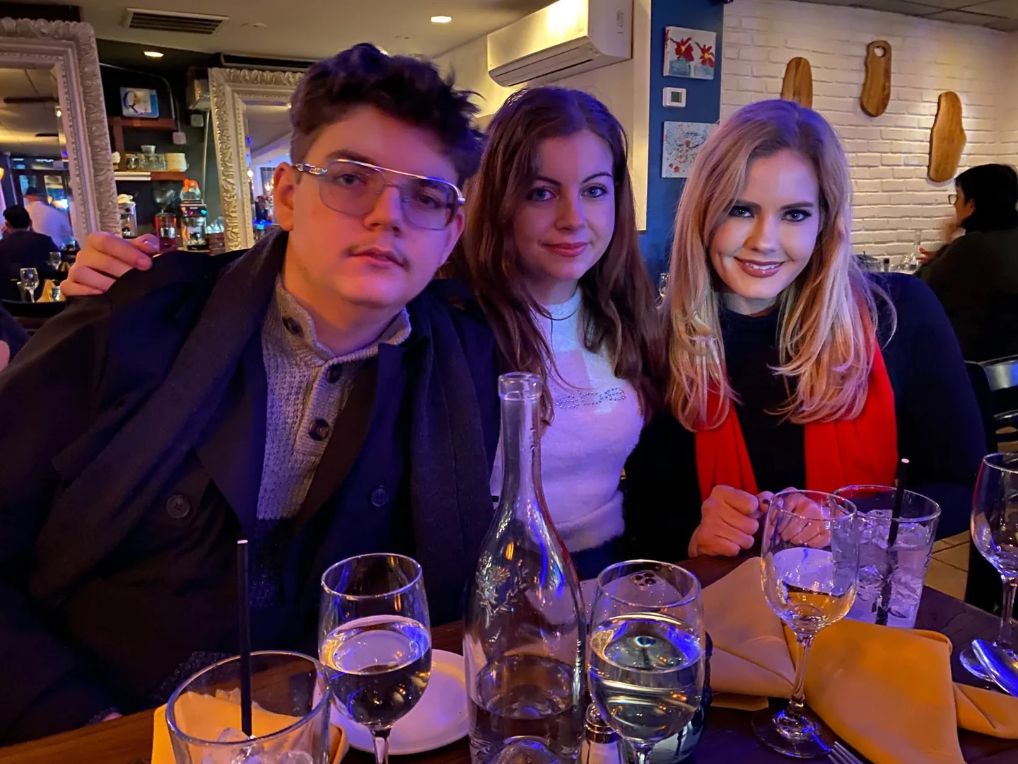 Three people together at a restaurant table