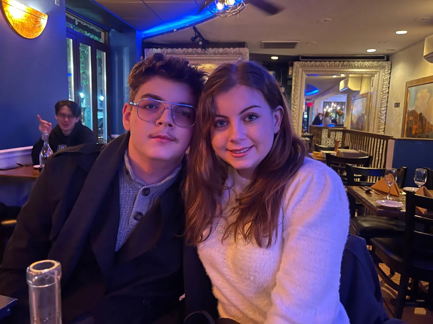 Two people seated together at a restaurant table