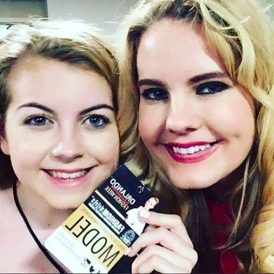 Two people smiling together at an event