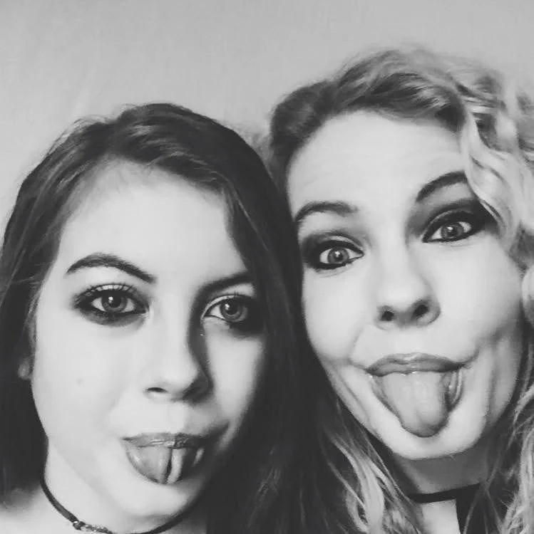 A playful black-and-white selfie of two people